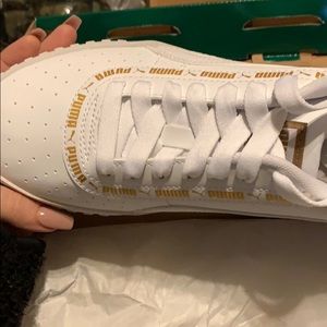 pink pumas with gold writing